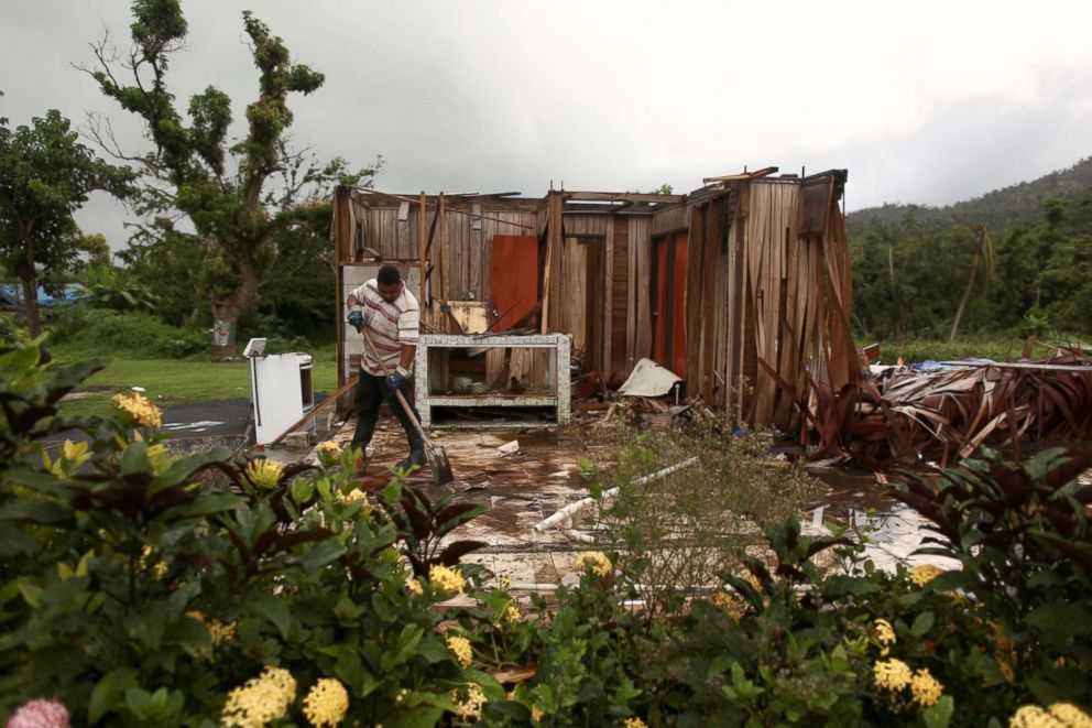 PHOTO: Miguel Garcia removes debris in what is left of his home after Hurricane Maria hit the island in September 2017, in Maunabo, Puerto Rico, January 27, 2018.