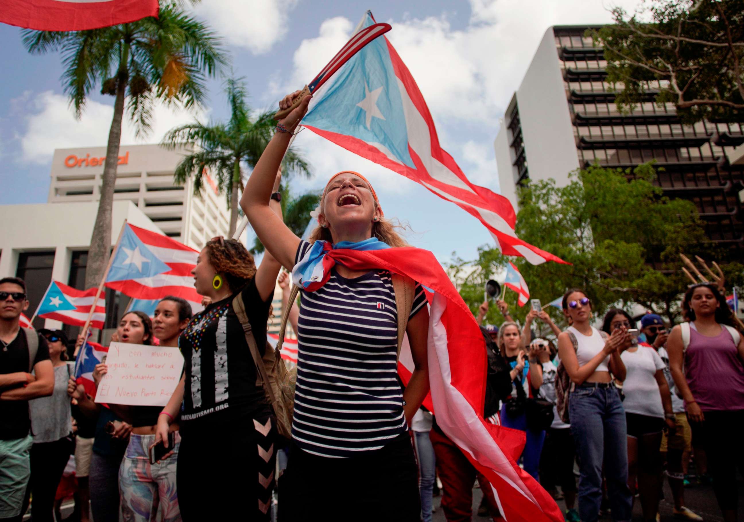 PHOTO: People march in San Juan, July 25, 2019, one day after the resignation of Puerto Rico Governor Ricardo Rossello. 