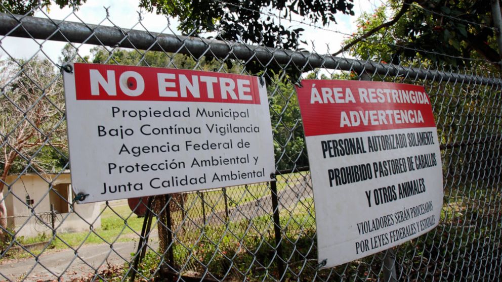 PHOTO: Warning signs are displayed on the fence surrounding the inactive Barceloneta Landfill site in Puerto Rico. About 300 tons of hazardous wastes are located in sinkholes on the property.