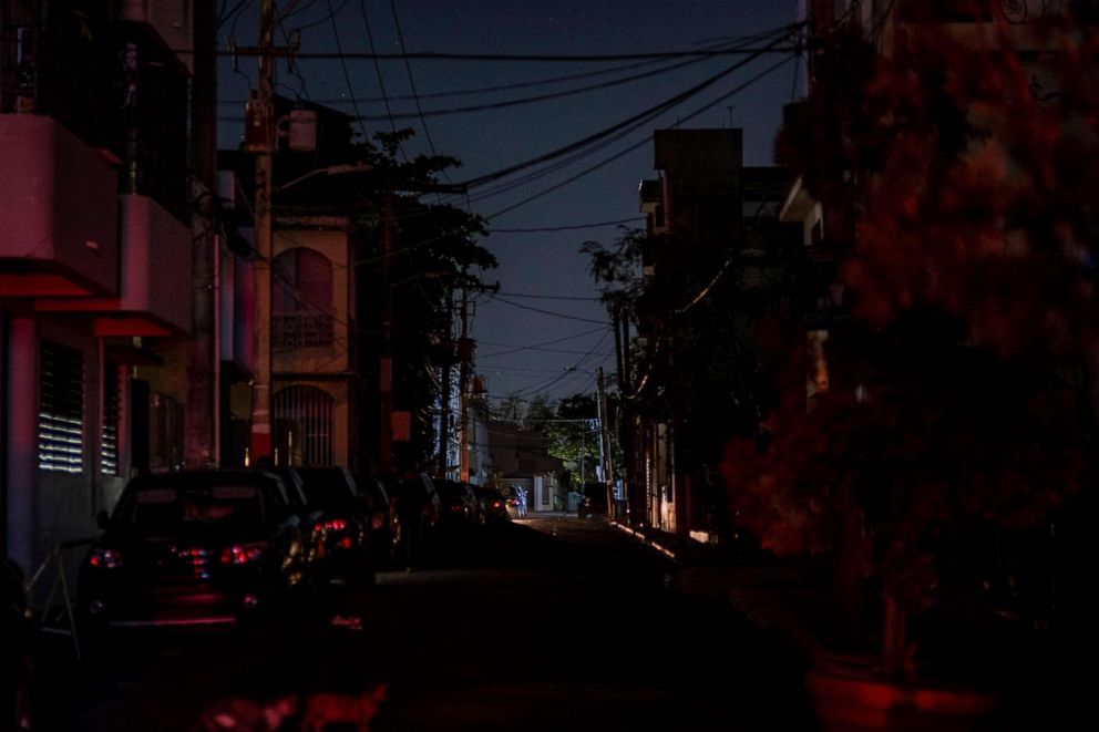PHOTO: The headlights of a car are seen on an otherwise dark street in San Juan, Puerto Rico after a major power outage hit the island, April 6, 2022.