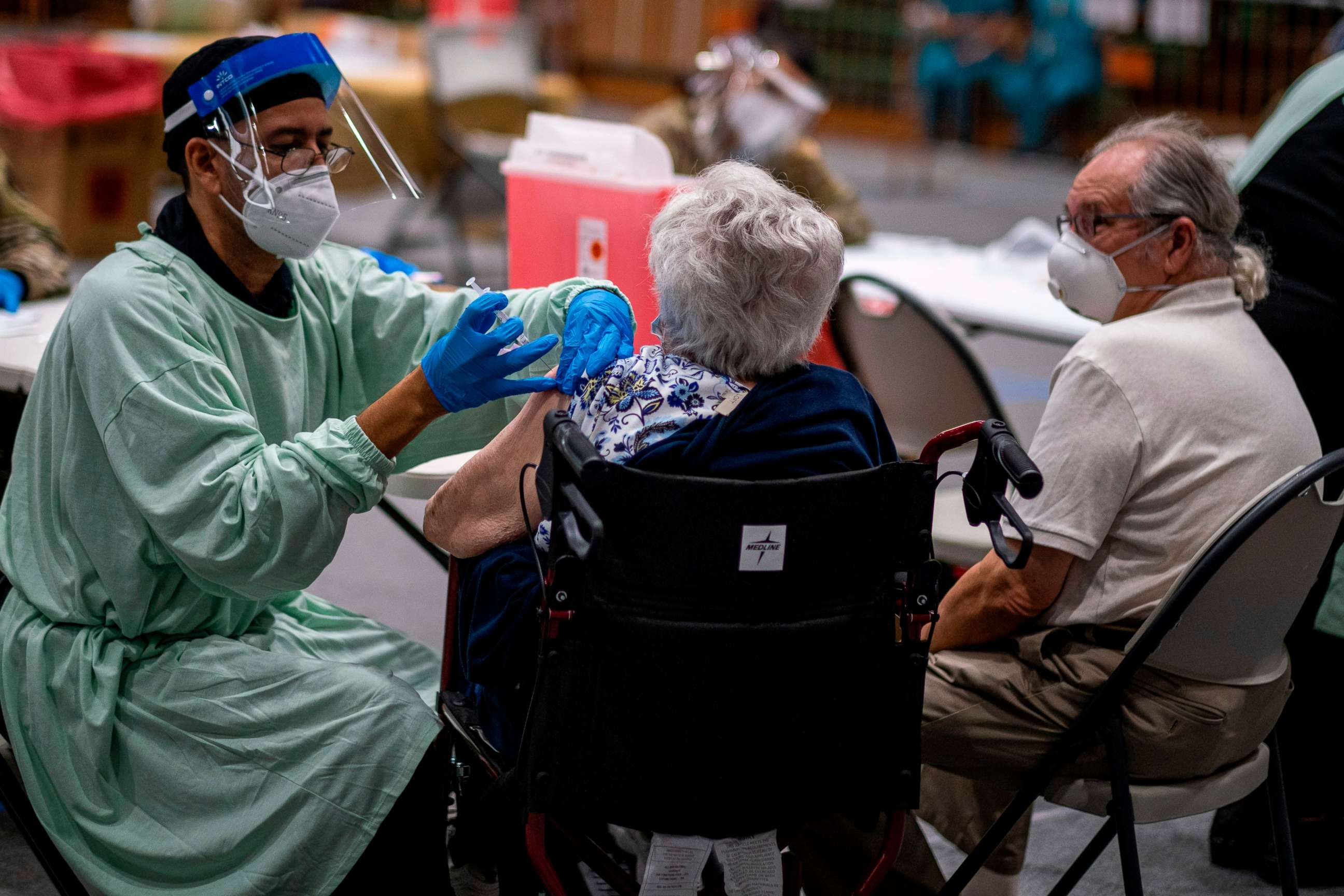 PHOTO: A health worker gives a shot of the Moderna vaccine at a Puerto Rico National Guard vaccination center during a priority COVID-19 vaccination program for the elderly, in San Juan, Puerto Rico on Feb. 8, 2021.