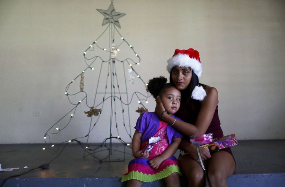 PHOTO: Cindy Vazquez Cruz, with her daughter Ruby Alamo, sit in the shelter for Hurricane Maria victims where they currently reside, Dec. 25, 2017, in Toa Baja, Puerto Rico. 