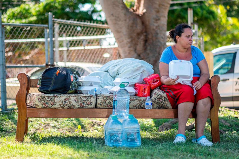 PHOTO: A woman sits on a sofa in a camp set up at a baseball field in Guanica, Puerto Rico on Jan. 11, 2020, after a powerful earthquake hit the island.