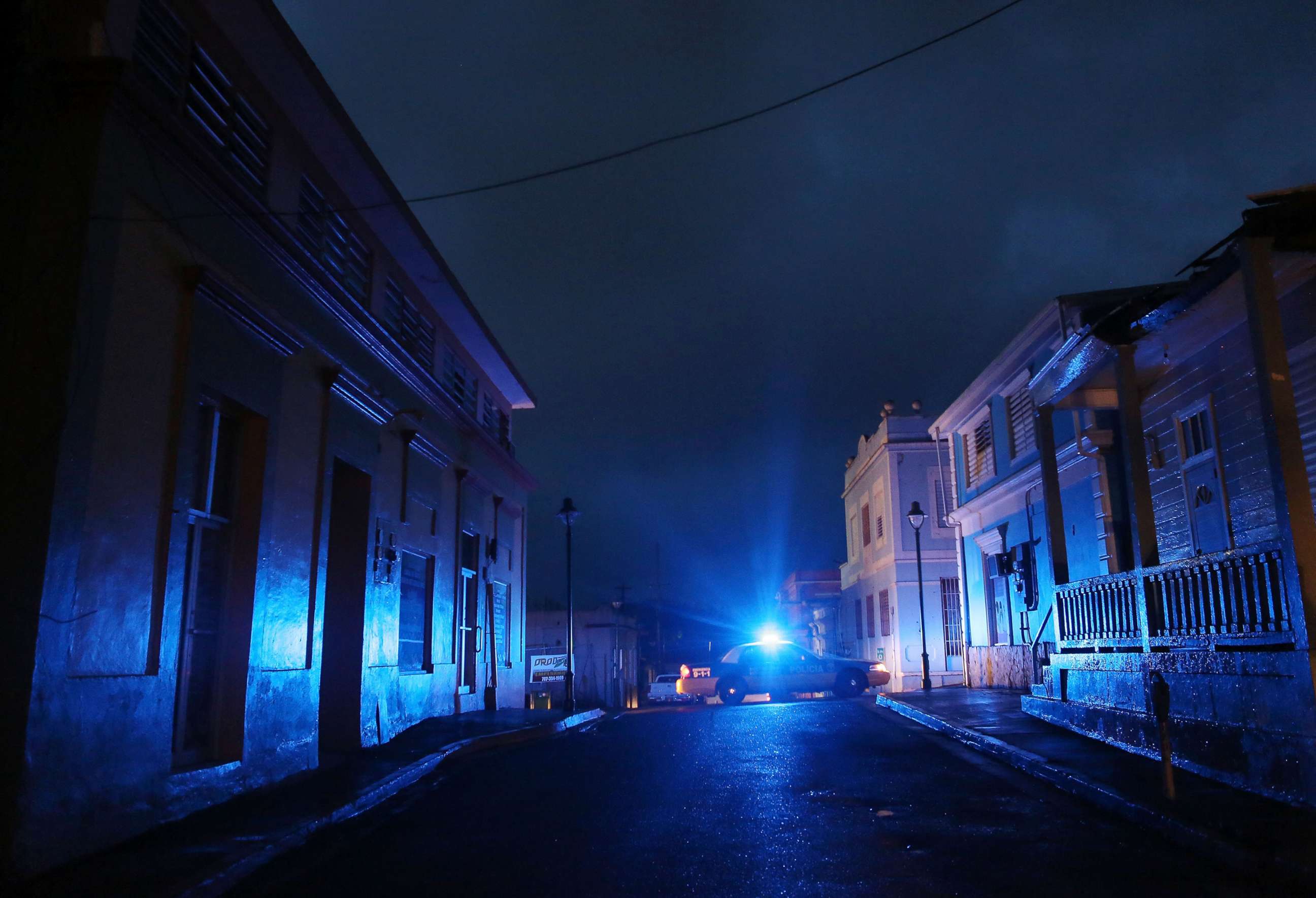 PHOTO: In this Oct. 11, 2017 file photo, A police car patrols on a darkened street three weeks after Hurricane Maria hit the island, in Aibonito, Puerto Rico. 