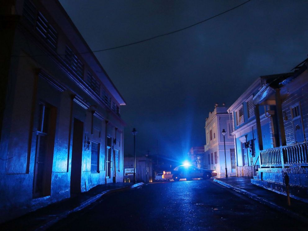 PHOTO: In this Oct. 11, 2017 file photo, A police car patrols on a darkened street three weeks after Hurricane Maria hit the island, in Aibonito, Puerto Rico.
