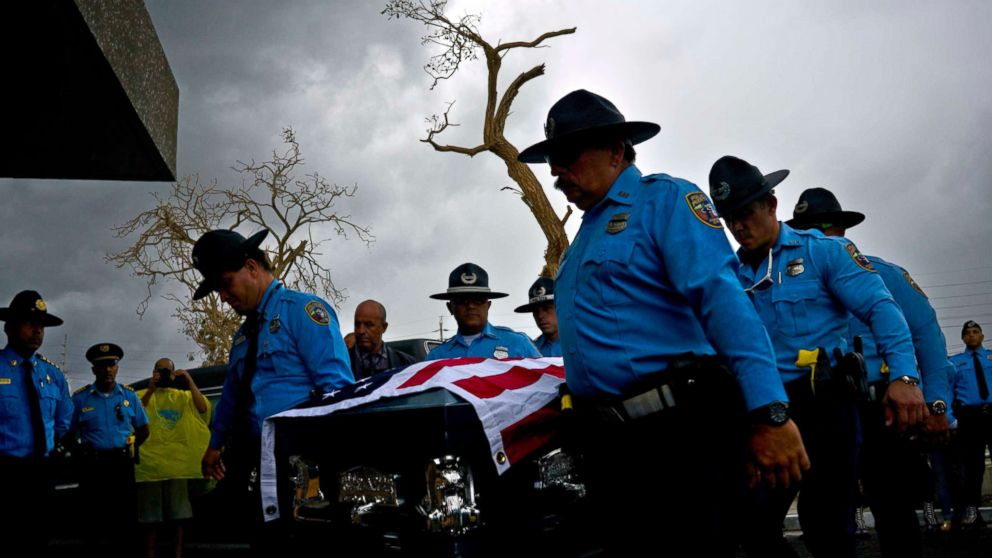 PHOTO: Honor guards carry the coffin of policeman Luis Angel Gonzalez Lorenzo, killed during Hurricane Maria when he tried to cross a river by car, during his funeral at the cemetery in Aguada, Puerto Rico, Sept. 29, 2017.