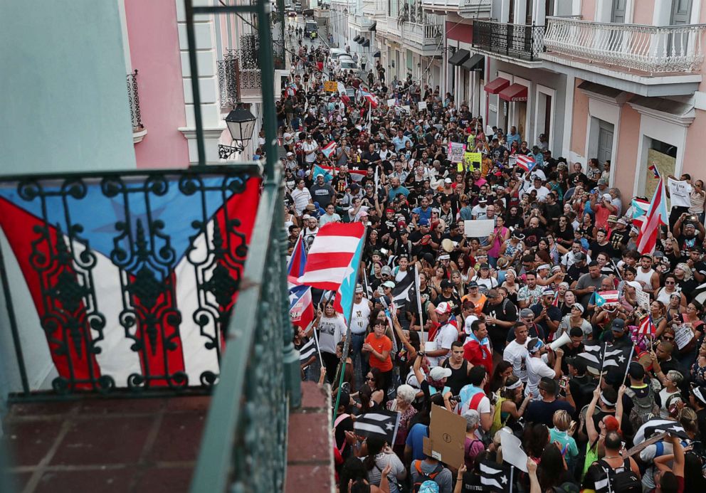 PHOTO: Protesters demonstrate against Ricardo Rossello, the Governor of Puerto Rico, near police that were manning a barricade set up along a street leading to the governor's mansion  on July 20, 2019, in Old San Juan, Puerto Rico.