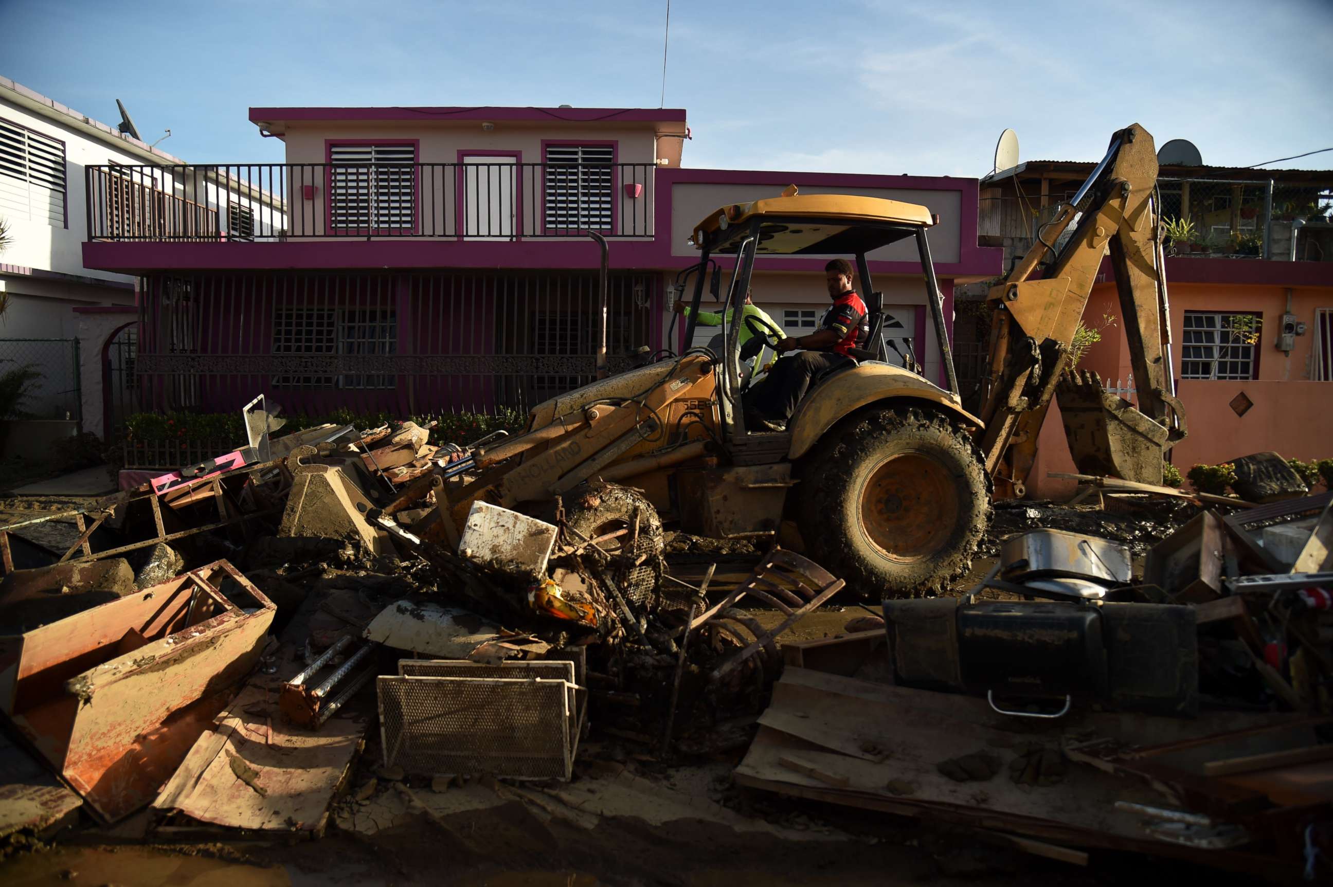 PHOTO: A man bulldozes furniture damaged and debris following Hurricane Maria on a street in Toa Baja, Puerto Rico, Sept. 25, 2017.