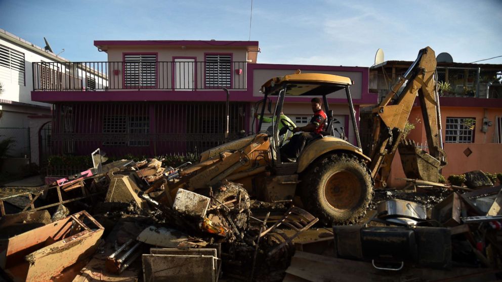 PHOTO: A man bulldozes furniture damaged and debris following Hurricane Maria on a street in Toa Baja, Puerto Rico, Sept. 25, 2017.