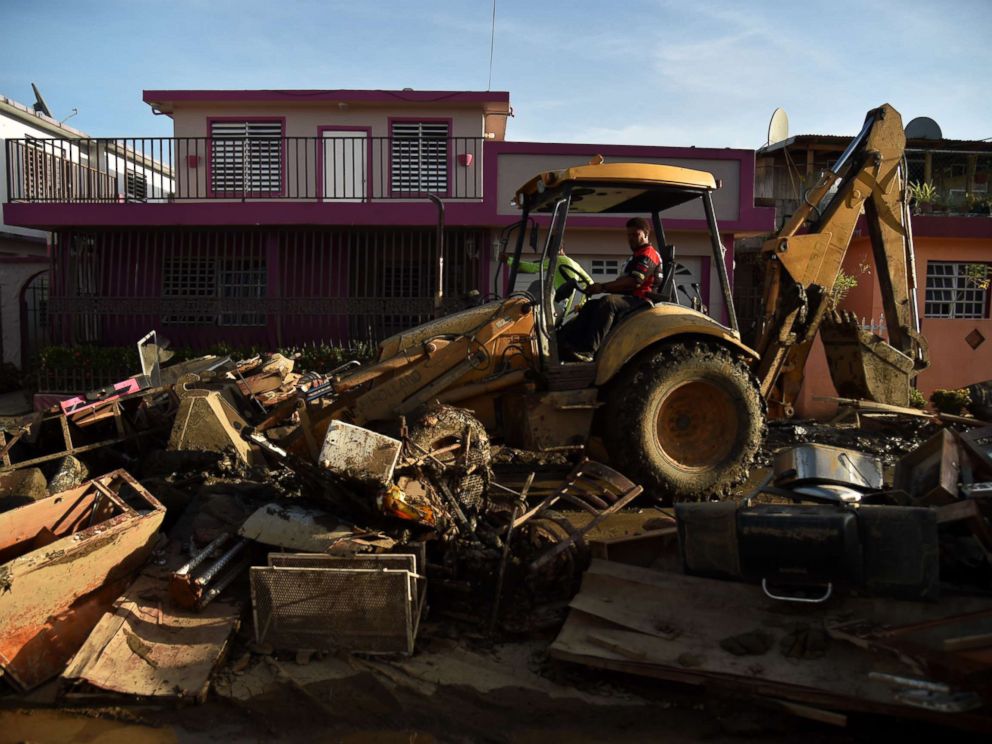 PHOTO: A man bulldozes furniture damaged and debris following Hurricane Maria on a street in Toa Baja, Puerto Rico, Sept. 25, 2017.