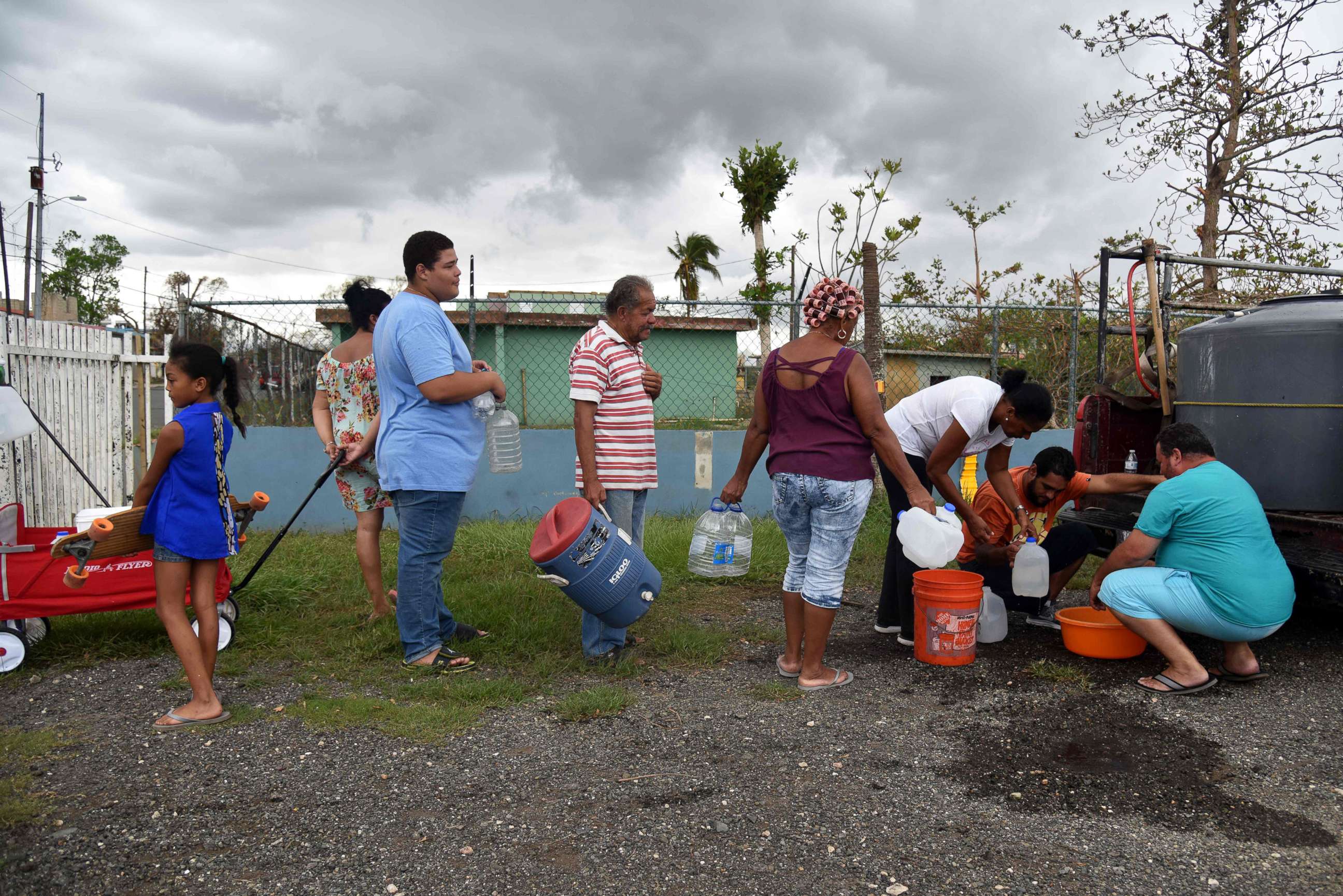 PHOTO: People take water from a tank in Vega Baja, Puerto Rico, Sept. 30, 2017, due to the lack of water after the passage of Hurricane Maria.
