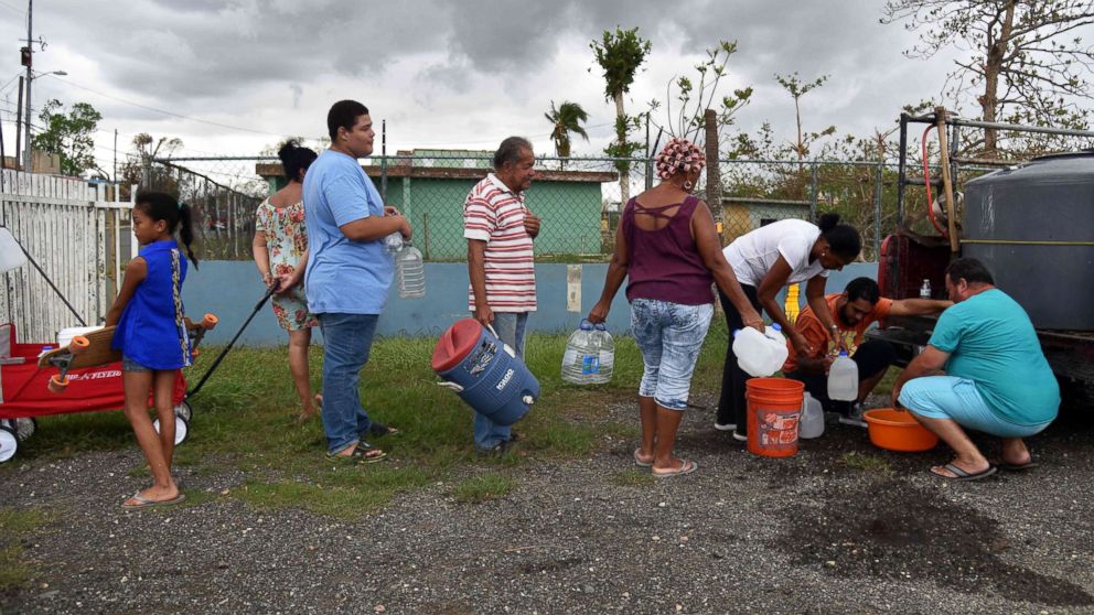 PHOTO: People take water from a tank in Vega Baja, Puerto Rico, Sept. 30, 2017, due to the lack of water after the passage of Hurricane Maria.
