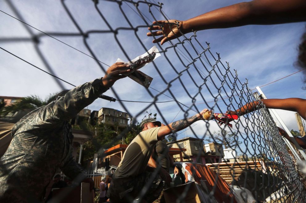 PHOTO: U.S. Army soldiers pass out food provided by FEMA to residents in a neighborhood without grid electricity or running water, Oct. 17, 2017, in San Isidro, Puerto Rico.