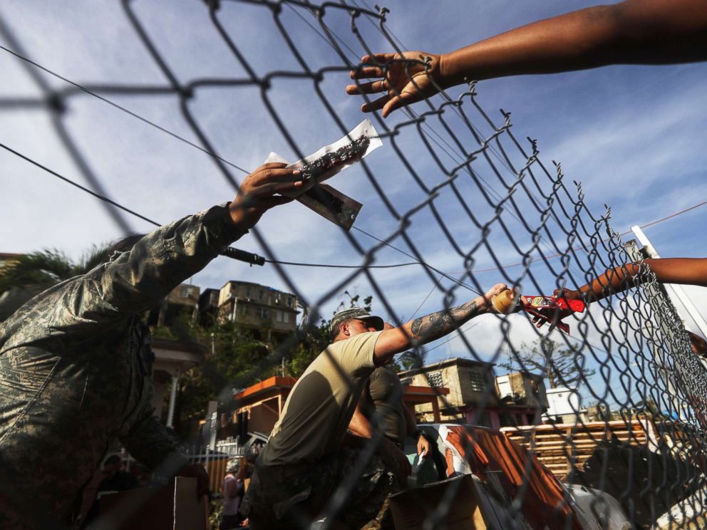 PHOTO: U.S. Army soldiers pass out food provided by FEMA to residents in a neighborhood without grid electricity or running water, Oct. 17, 2017, in San Isidro, Puerto Rico.