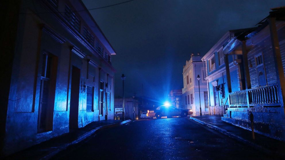 PHOTO: A police car patrols on a darkened street three weeks after Hurricane Maria hit the island, Oct. 11, 2017, in Aibonito, Puerto Rico.