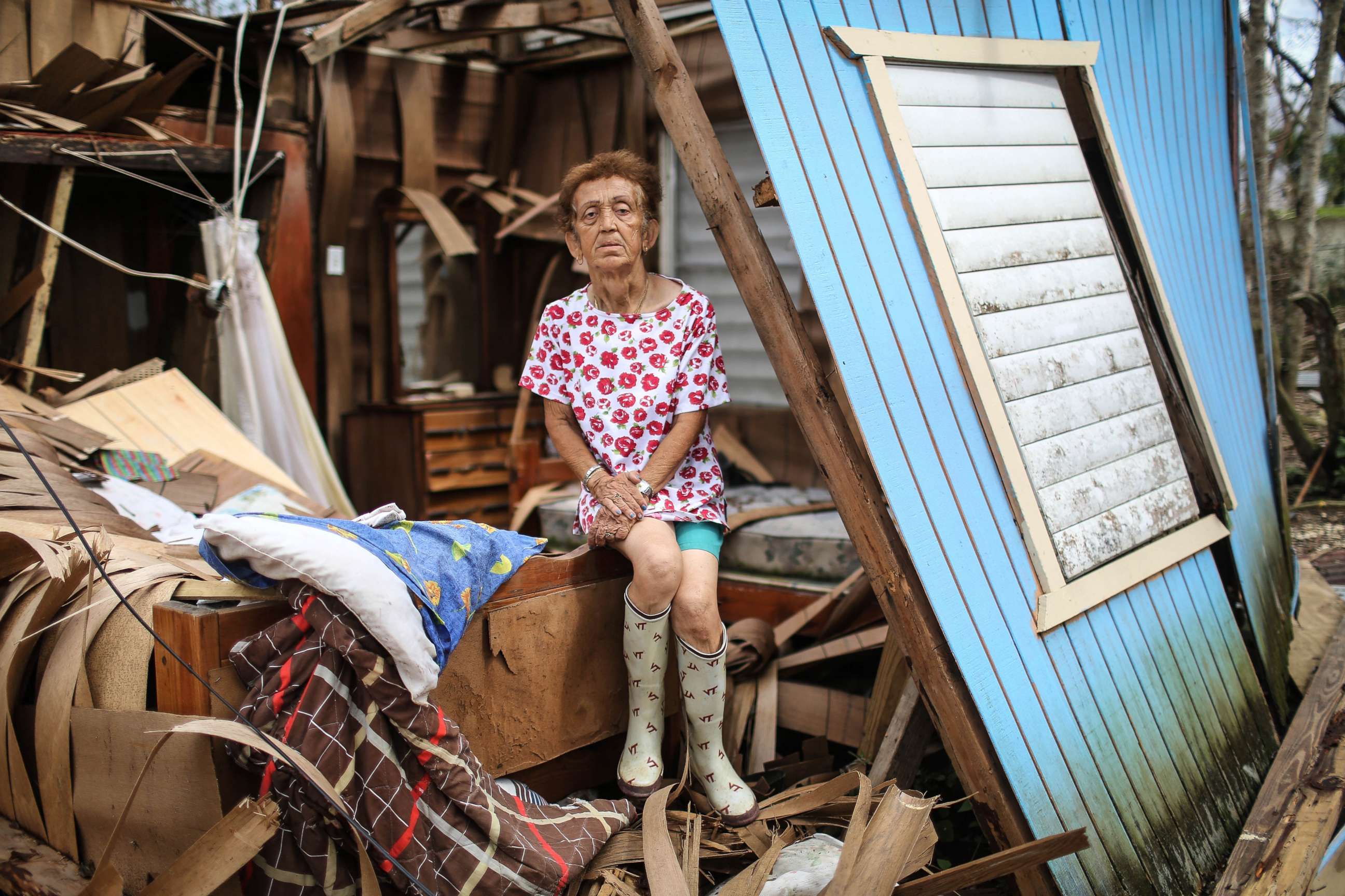 PHOTO: Sonia Torres poses in her destroyed home, while taking a break from cleaning, three weeks after Hurricane Maria hit the island, Oct. 11, 2017, in Aibonito, Puerto Rico.