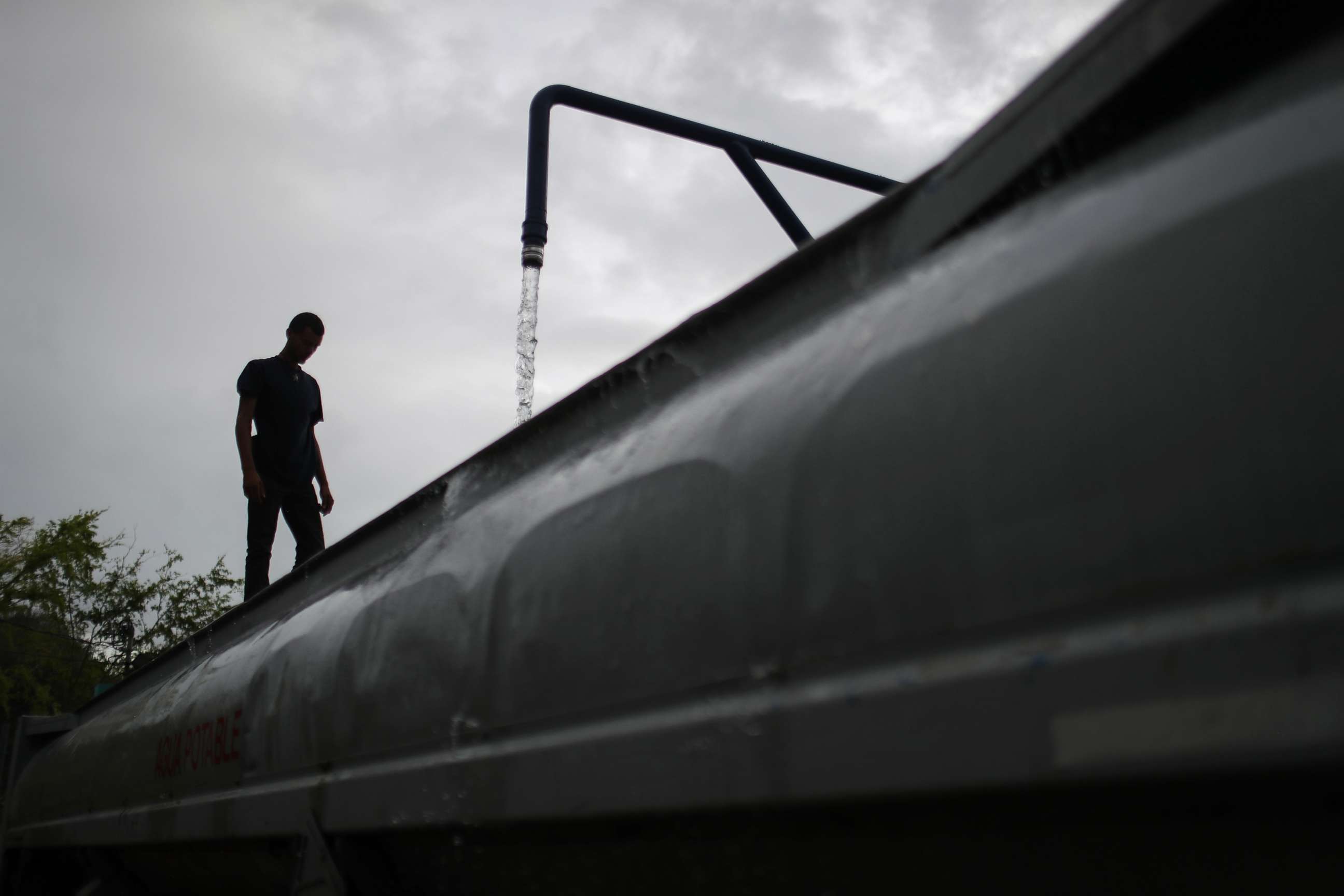 PHOTO: A worker fills a potable water truck with water provided at a pump by water authorities, Oct. 15, 2017, in Dorado, Puerto Rico.