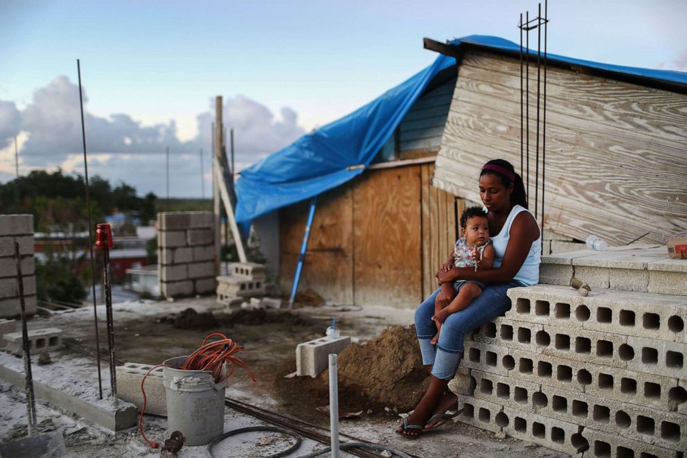 PHOTO: Mother Isamar holds her baby Saniel at their home under reconstruction following Hurricane Maria, Dec. 23, 2017, in San Isidro, Puerto Rico.