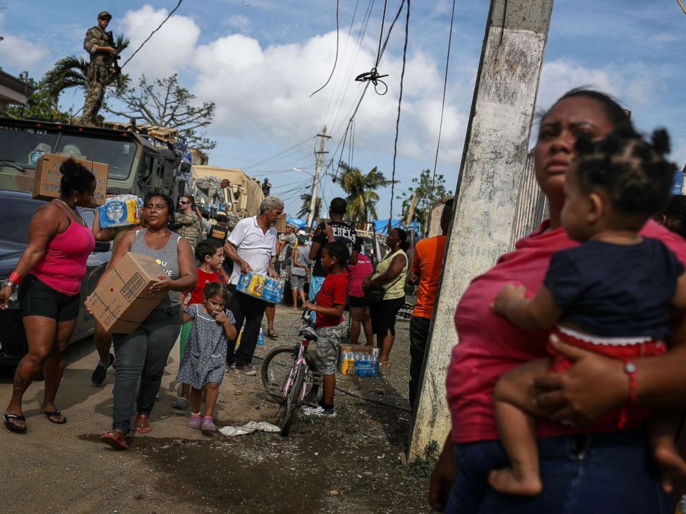PHOTO: Residents gather to receive food and water from FEMA in a neighborhood without grid electricity or running water on Oct. 17, 2017 in San Isidro, Puerto Rico.