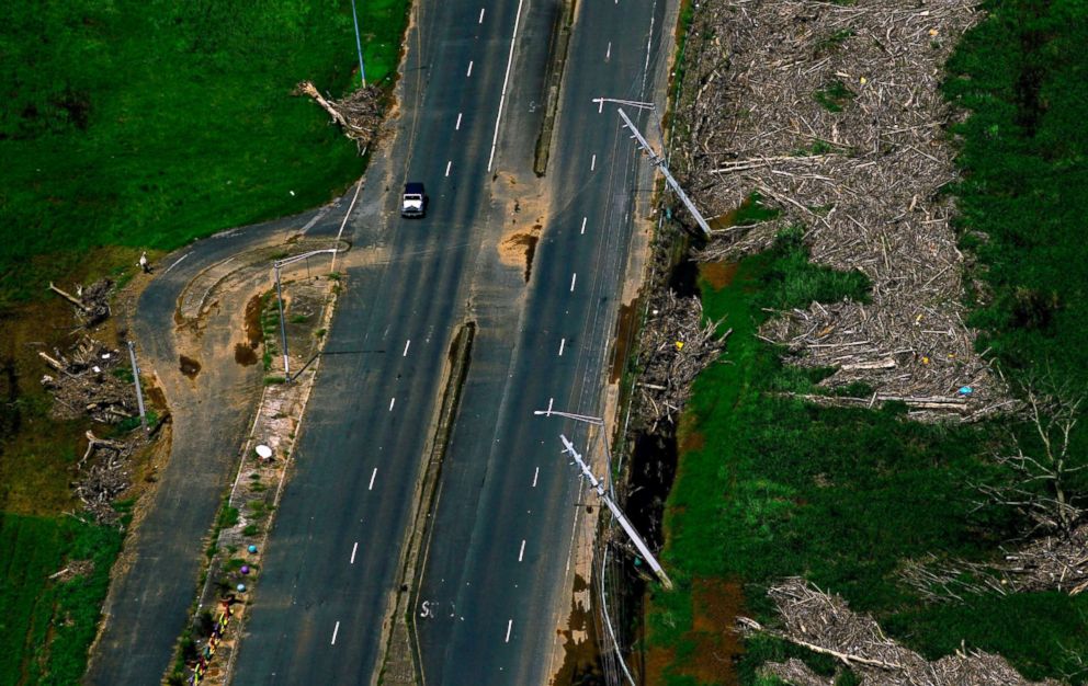 PHOTO: Power lines stand at an angle surrounded by vegetation that was torn down by Hurricane Maria in Barceloneta, Puerto Rico, Oct. 15, 2017.