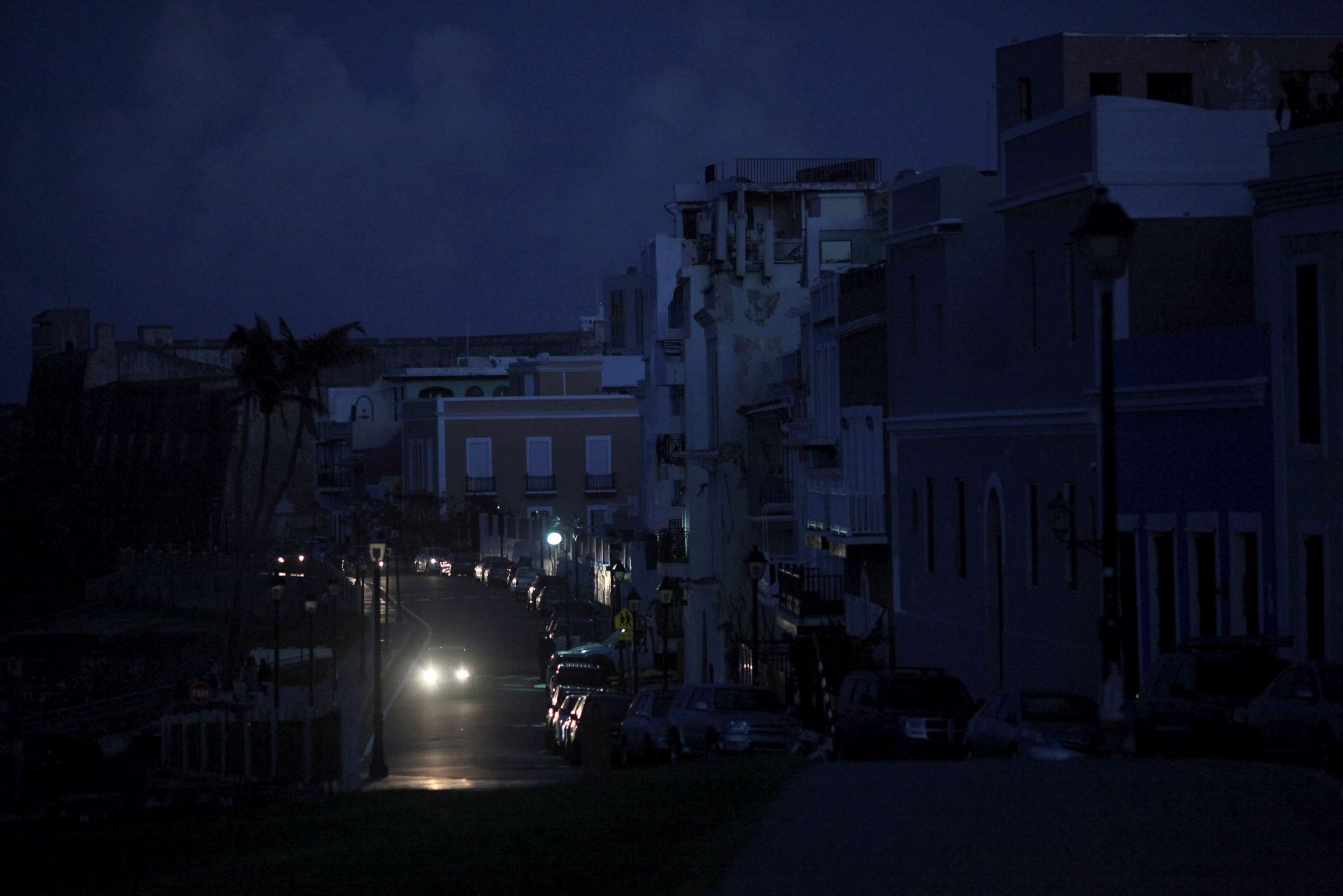 PHOTO: A car drives through a dark street in Old San Juan, Puerto Rico, Oct. 26, 2017, after Hurricane Maria hit the island and damaged the power grid in September.