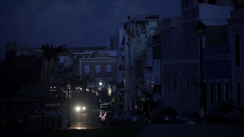PHOTO: A car drives through a dark street in Old San Juan, Puerto Rico, Oct. 26, 2017, after Hurricane Maria hit the island and damaged the power grid in September.