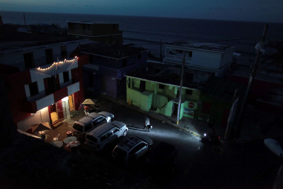 PHOTO: A house is lit up with the help of a generator next to houses in the dark, after Hurricane Maria hit the island and damaged the power grid in September, in Old San Juan, Puerto Rico on Oct. 26, 2017.