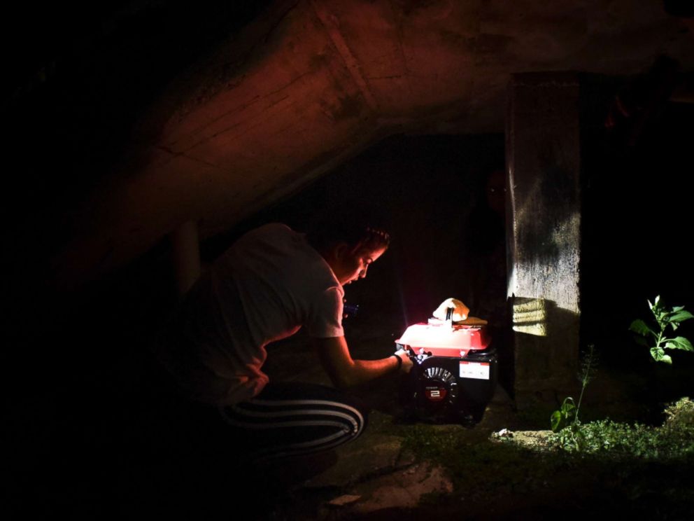 PHOTO: Barrio Patron resident Karina Santiago Gonzalez works on a small power plant in Morovis, Puerto Rico on Dec. 21, 2017.