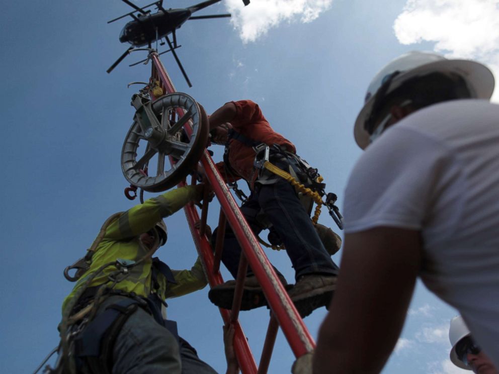 PHOTO: Workers from Montana-based Whitefish Energy Holdings help fix the islands power grid, damaged during Hurricane Maria in September, in Manati, Puerto Rico, Oct. 25, 2017.