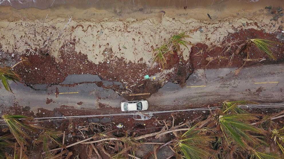 PHOTO: A car drives on a damaged road in the aftermath of Hurricane Maria in Humacao, Puerto Rico on Oct. 2, 2017.