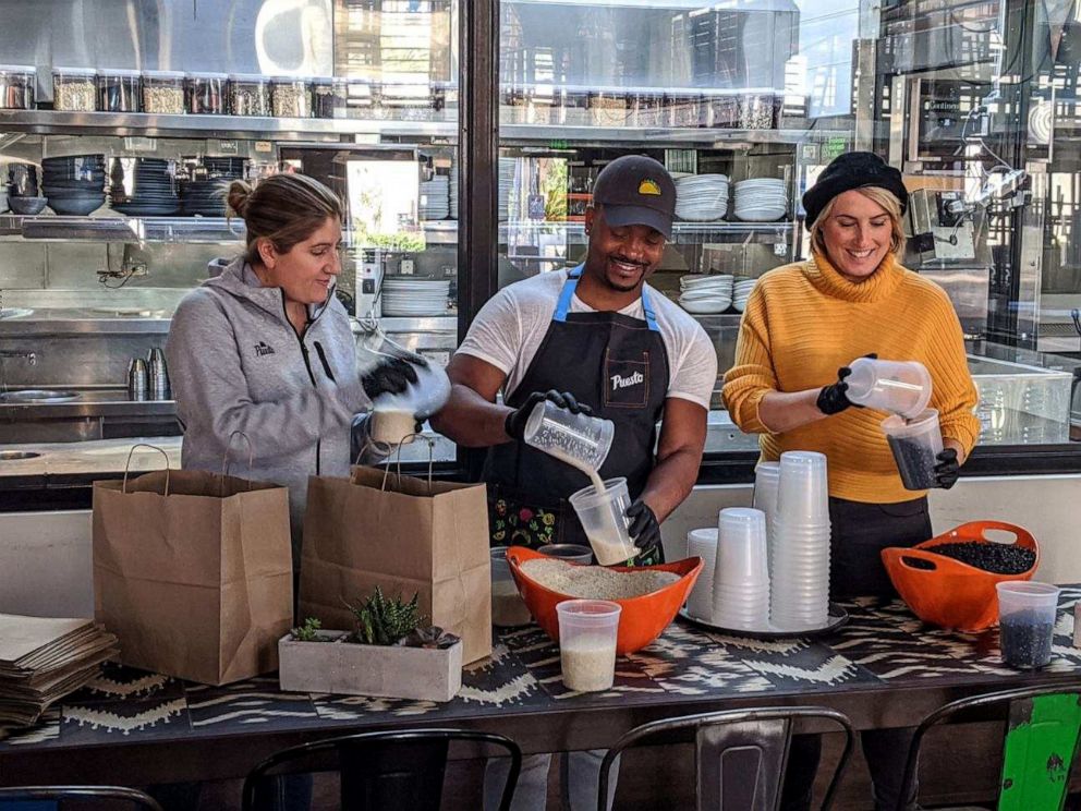 PHOTO: Puesto team members, from r-l, Marie Thomasset, Louis Ward and Amy Grave, pack care packages throughout the week. 