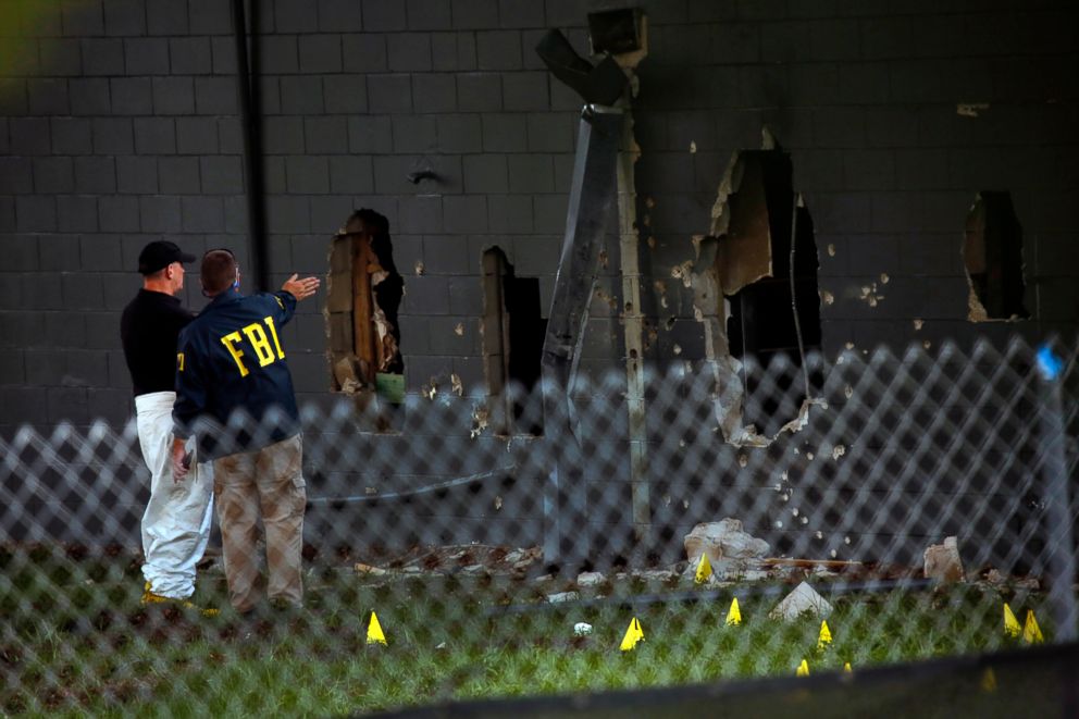 PHOTO: FBI agents investigate near the damaged rear wall of the Pulse Nightclub, June 12, 2016, in Orlando, Fla.