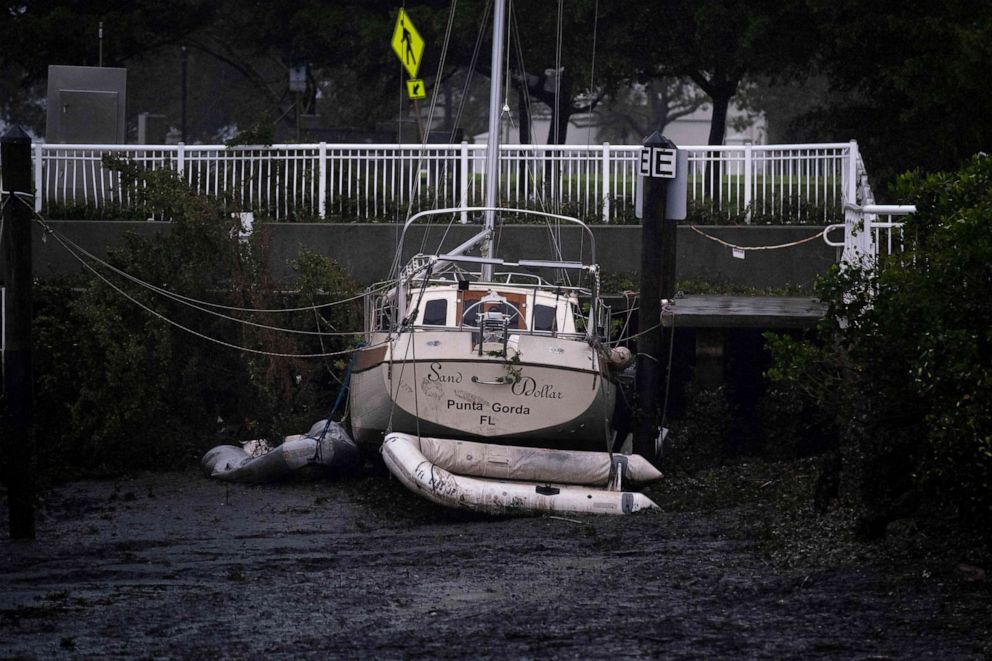 PHOTO: A sail boat lies on the bottom of Charlotte Harbor as the tide retreats as the eye of Hurricane Ian passes by in Punta Gorda, Fla., on Sept. 28, 2022.