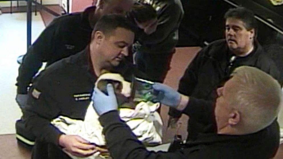 Police officers and firefighters in North Reading, Mass., are captured on surveillance video saving a choking puppy.