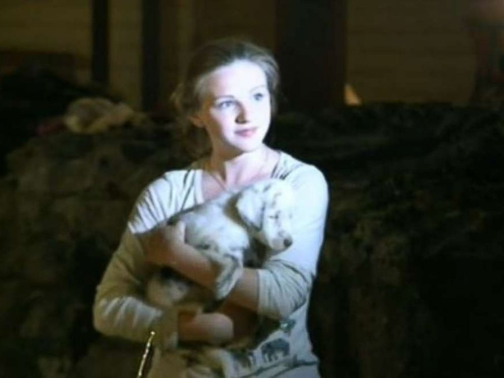 Owner Laura Wests daughter holds Toffee after the 7-week-old puppy was rescued from a 50-foot hole in Huntsville, Ala., on Saturday, June 30, 2018.