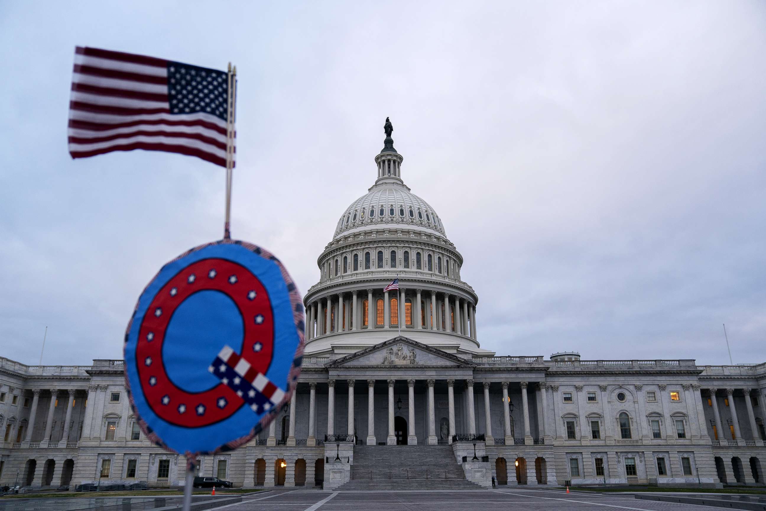 PHOTO: A demonstrator holds a "Q" sign outside the U.S. Capitol in Washington, D.C., Jan. 6, 2021.