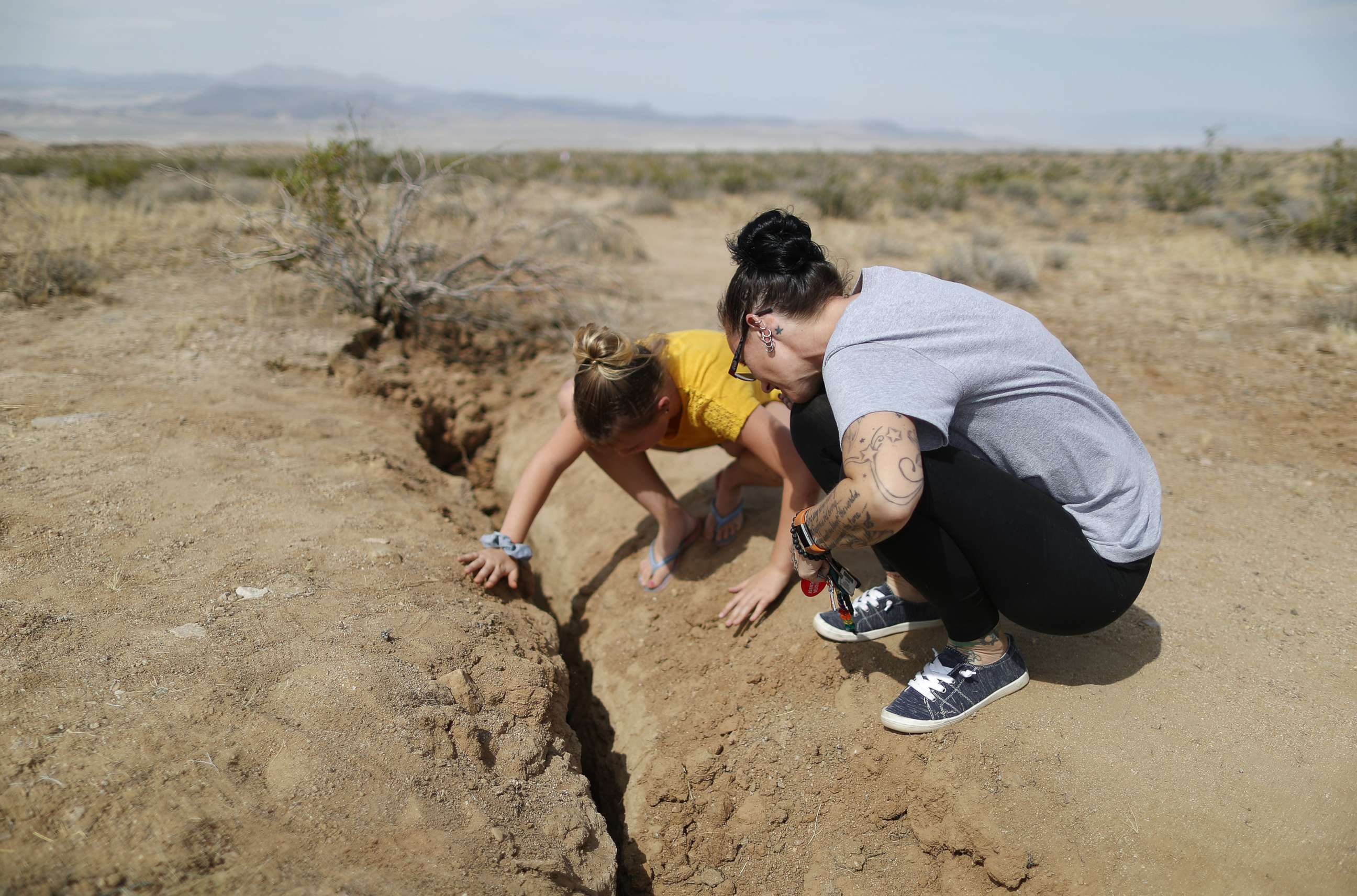 PHOTO: Ridgecrest residents inspect a recent fault rupture following two large earthquakes in the area, July 7, 2019, near Ridgecrest, Calif.