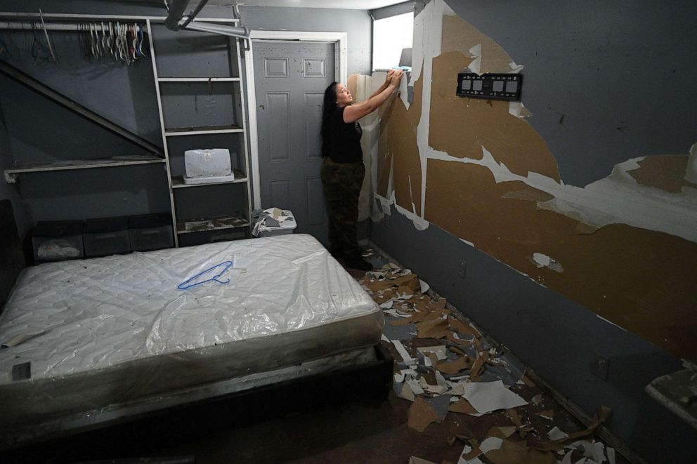 PHOTO: Resident Danette Rivera stands by a window that she tried to climb out of as flood waters from the remnants of Hurricane Ida rose in her basement apartment in the Woodside neighborhood of Queens in New York, Sept. 6, 2021.