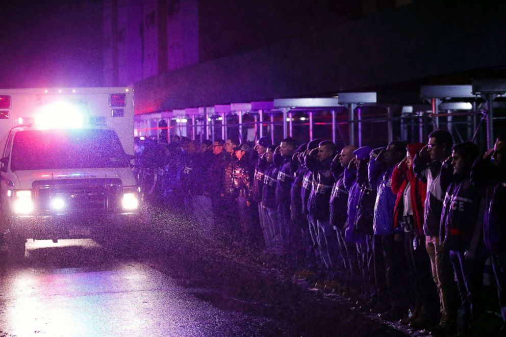 PHOTO: Officers salute a procession as the remains of slain Detective Brian Simonsen are removed from Jamaica Hospital, Feb. 12, 2019, in the Queens borough of N.Y.