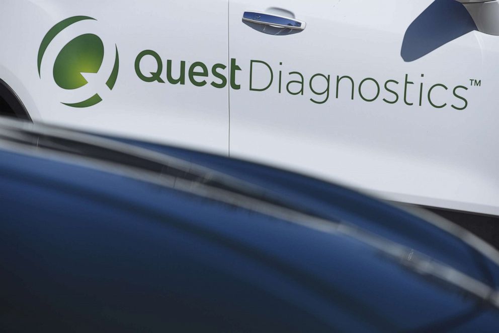 PHOTO: Quest Diagnostics Inc. signage is displayed on a vehicle parked at a drive-through coronavirus testing facility at Bergen Community College in Paramus, N.J., March 21, 2020. 