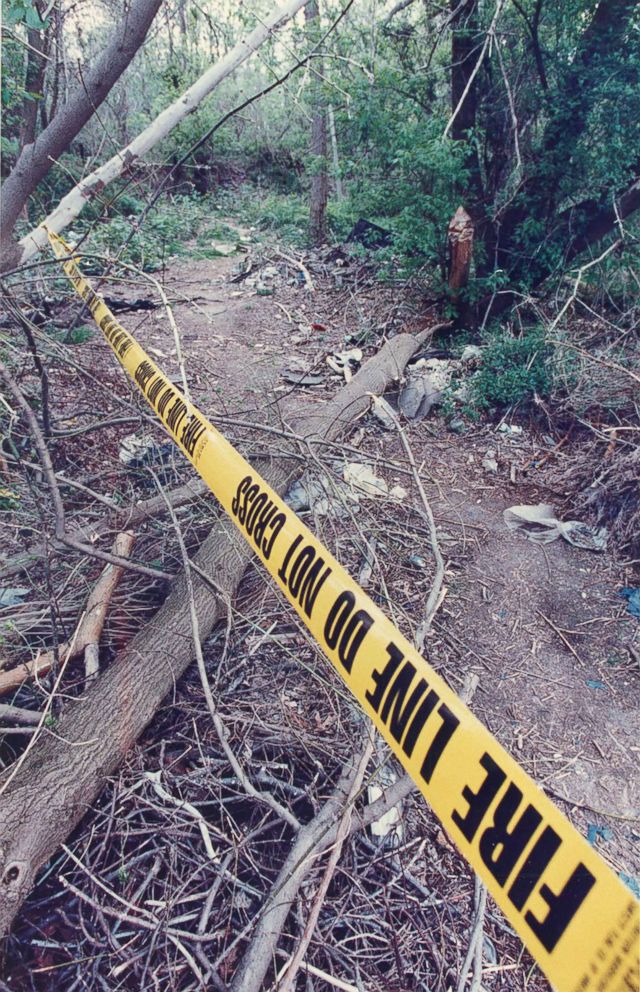 PHOTO: A police line marks the path in woods where Quiana Dees, 12, was found shot in the head.