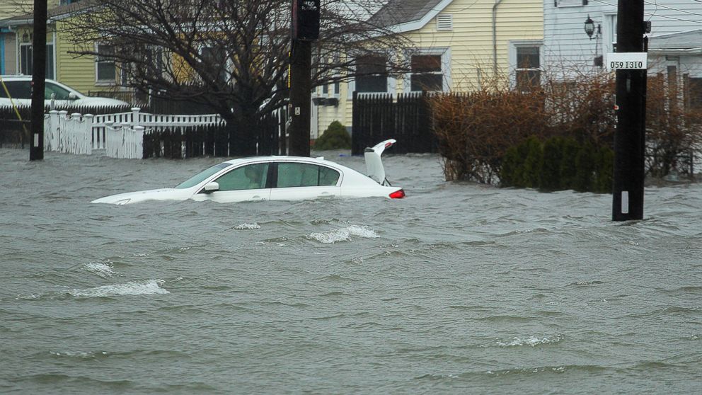 A car along Sea Street, is under several feet of water during the storm, Friday, March 2, 2018 in Quincy, Mass. 