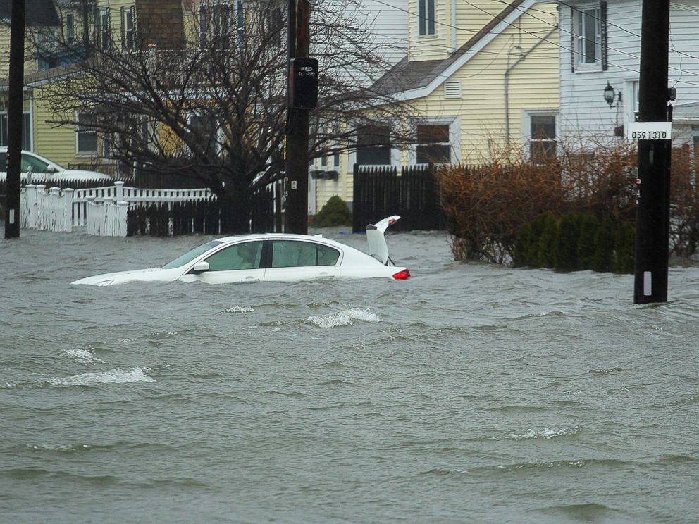 A car along Sea Street, is under several feet of water during the storm, Friday, March 2, 2018 in Quincy, Mass.