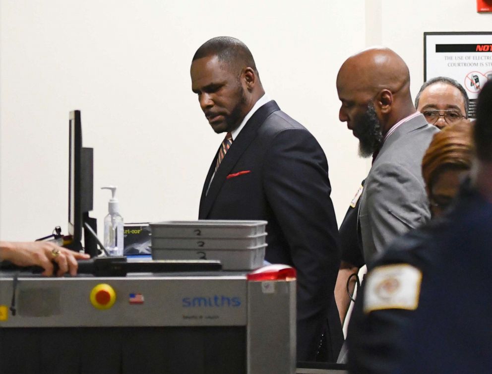 PHOTO: Musician R. Kelly, center, goes through security after he arrives at the Daley Center for a hearing in his child support case, May 8, 2019, in Chicago.