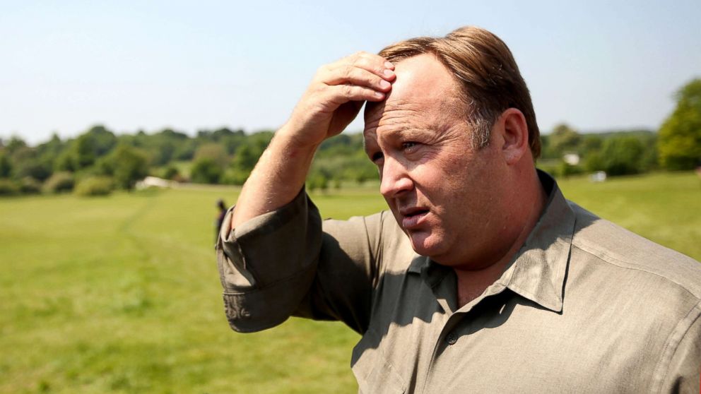 Alex Jones addresses media and protesters in the encampment outside The Grove hotel, June 6, 2013, in Watford, England.