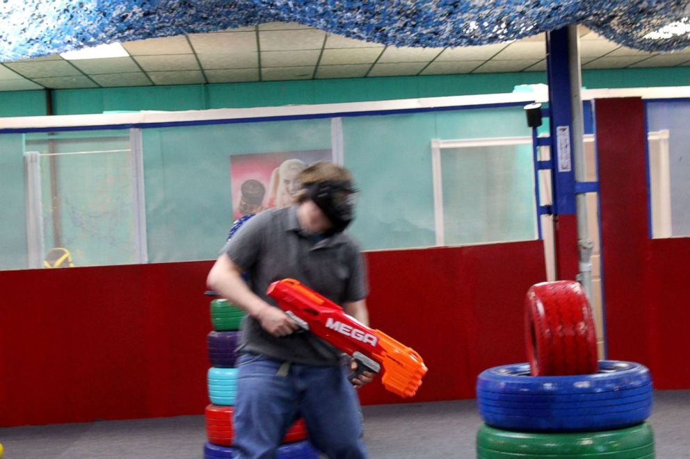 PHOTO: Participants take part in a rage room to release tension and stress.