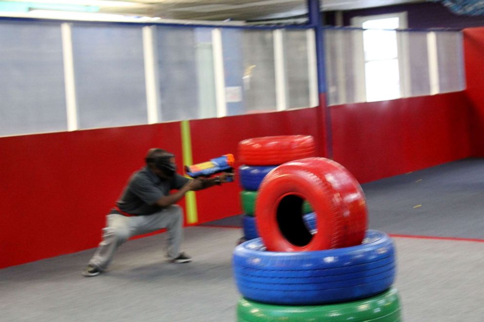 PHOTO: Participants take part in a rage room to release tension and stress.