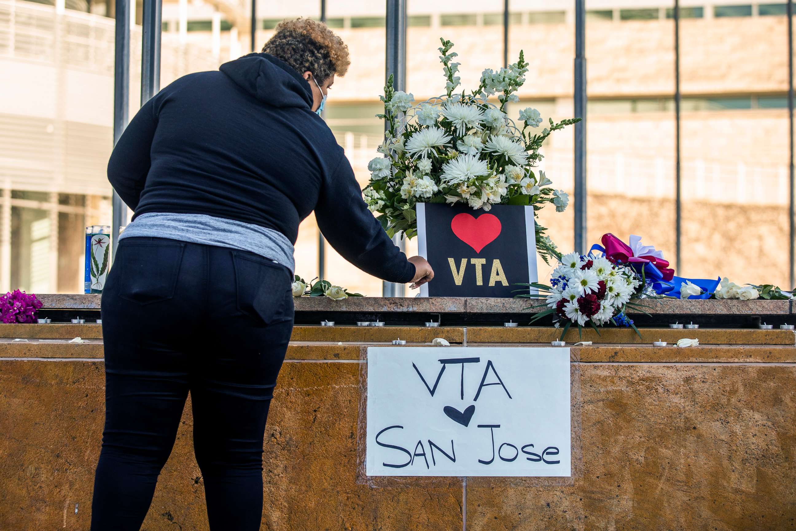 PHOTO: HERO Tent President Kiana Simmons tends to a vigil organized by her group following the mass shooting at the Valley Transportation Authority (VTA) light-rail yard, outside City Hall, May 26, 2021, in San Jose, Calif.