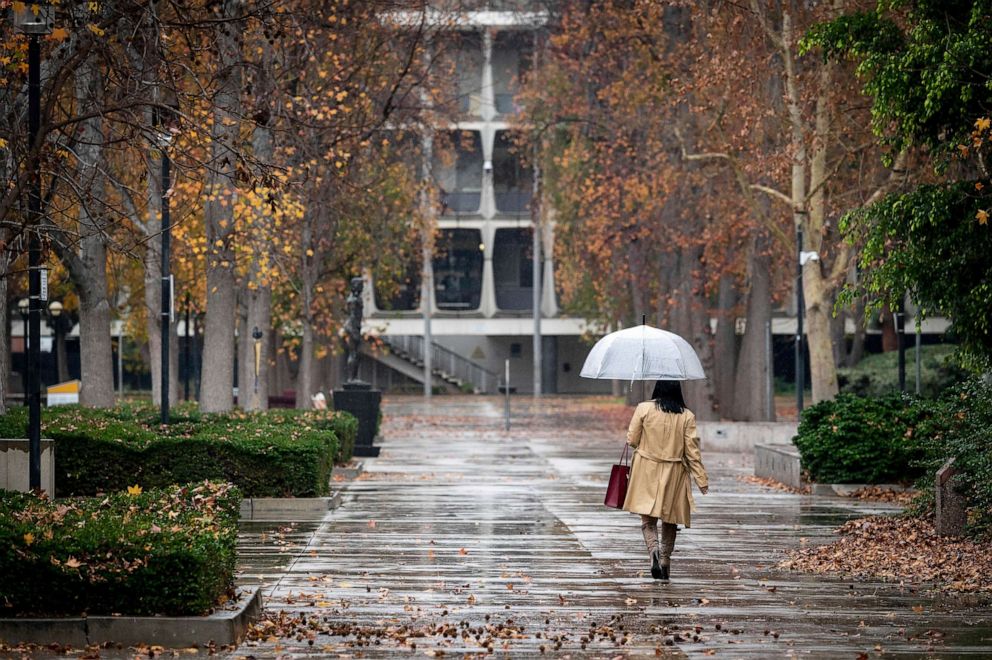 PHOTO: Umbrellas come out near the Van Nuys, Calif., courthouse as rain begins to fall, Dec. 27, 2022.