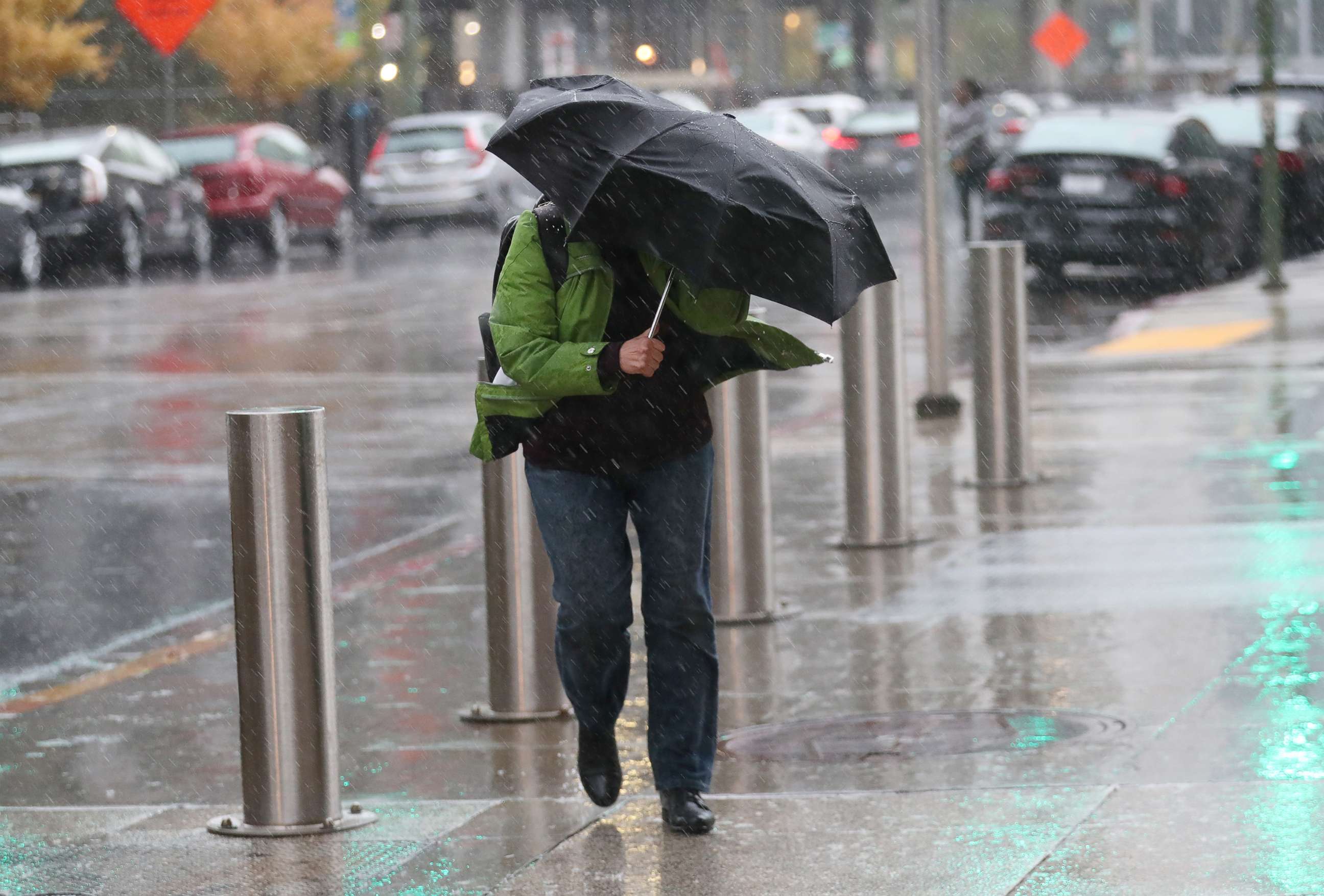 PHOTO: A woman fights the wind and rain as she walks along 12th Street near Broadway in Oakland, Calif., Nov. 26, 2019. 